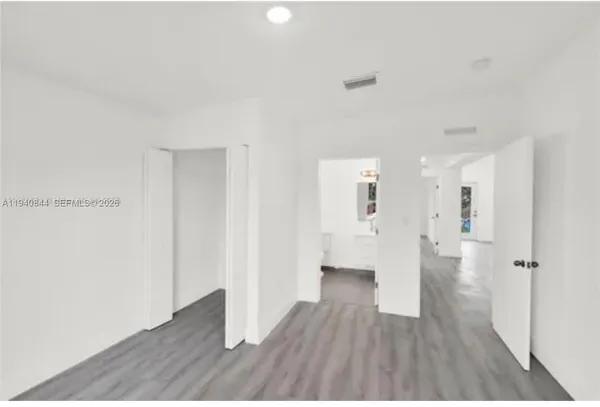 a kitchen with kitchen island a sink cabinets and stainless steel appliances