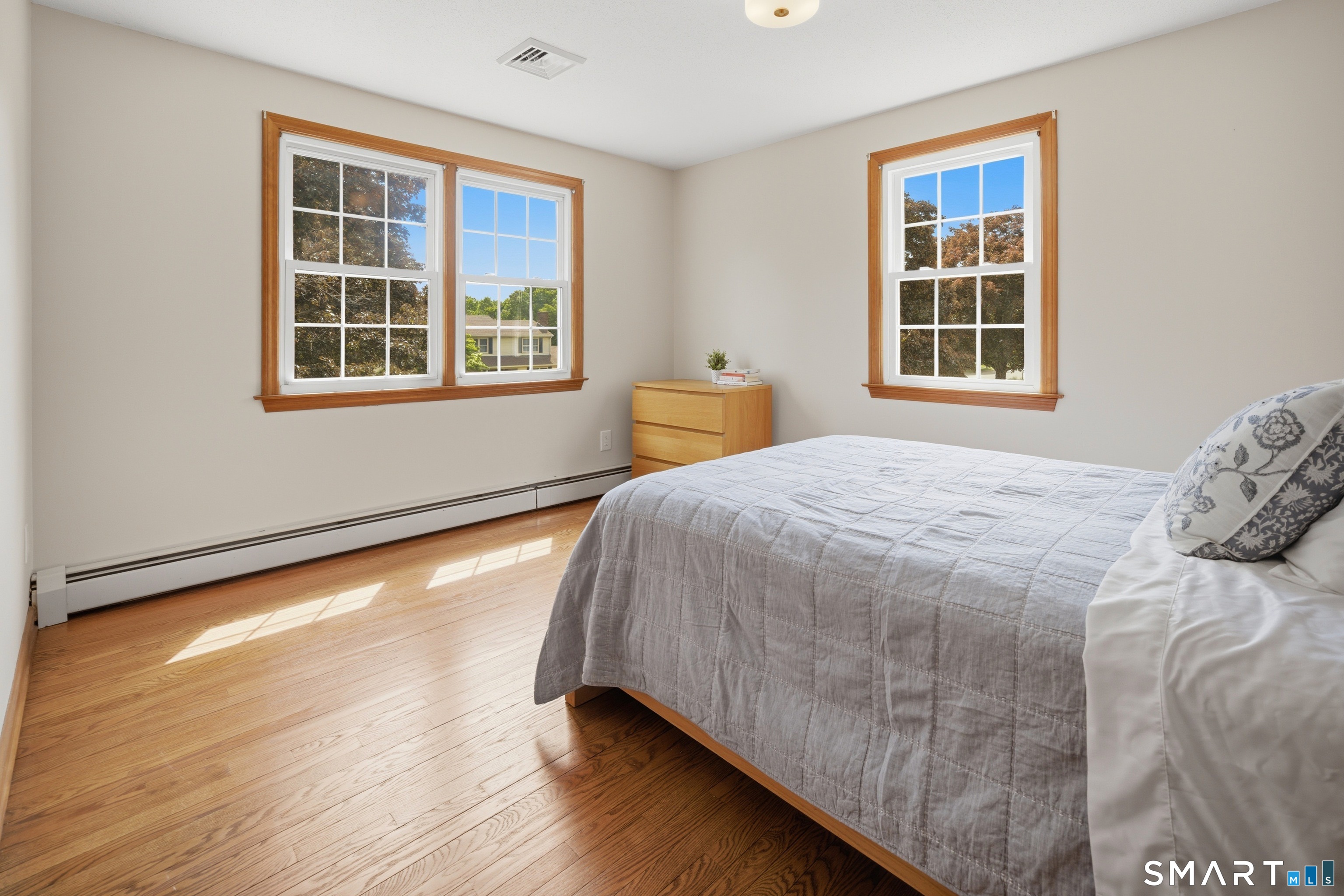 211 Valley View Road Manchester, CT 06040 - Photo 30 of 39 a bedroom with a bed and wooden floor