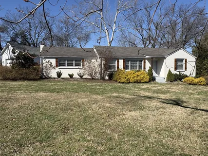 a front view of a building with a yard