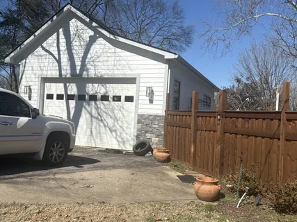 a view of a house with a backyard and porch