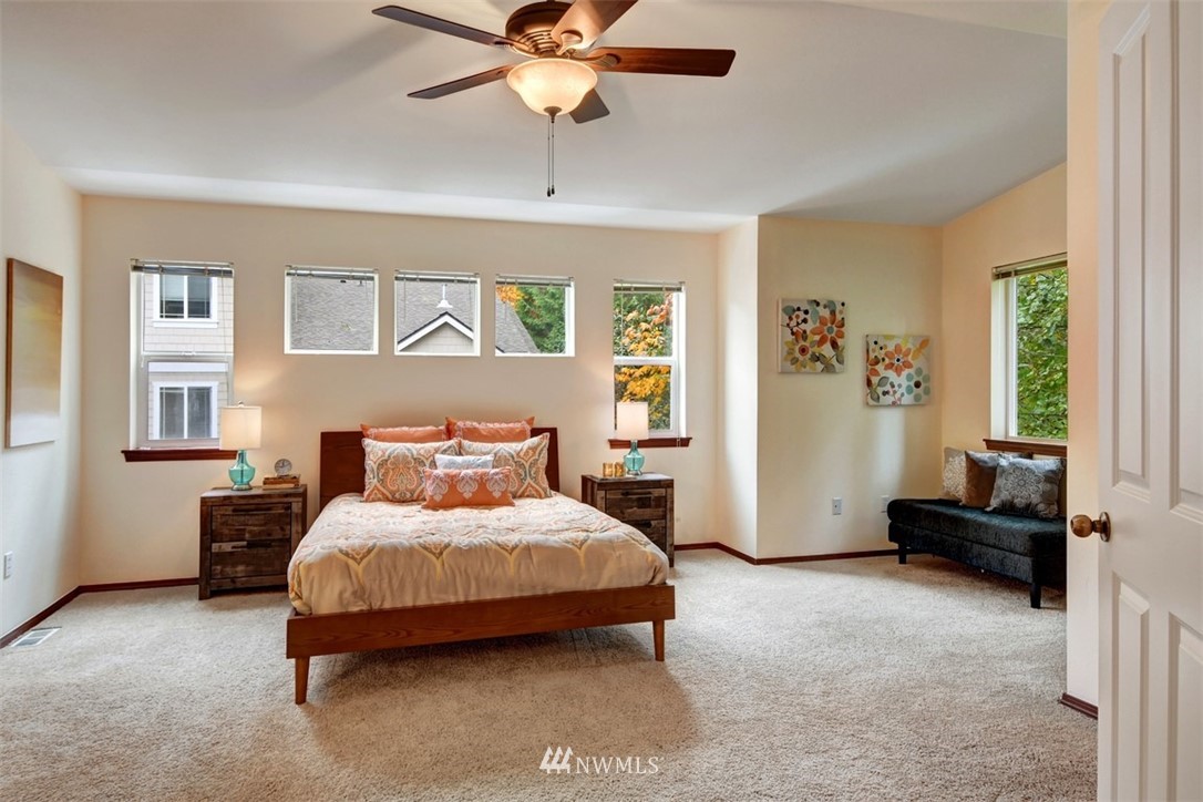 21622 11th Court Southeast Bothell, WA 98021 - Photo 12 of 19 a bedroom with a bed and a chandelier