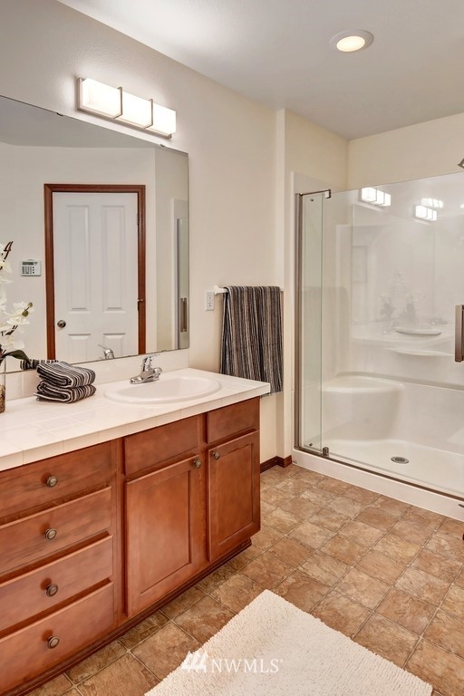 21622 11th Court Southeast Bothell, WA 98021 - Photo 14 of 19 a bathroom with a double vanity sink and a mirror