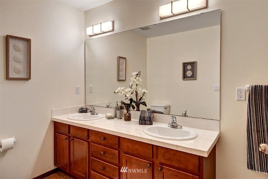 21622 11th Court Southeast Bothell, WA 98021 - Photo 15 of 19 a bathroom with a double vanity sink and a mirror