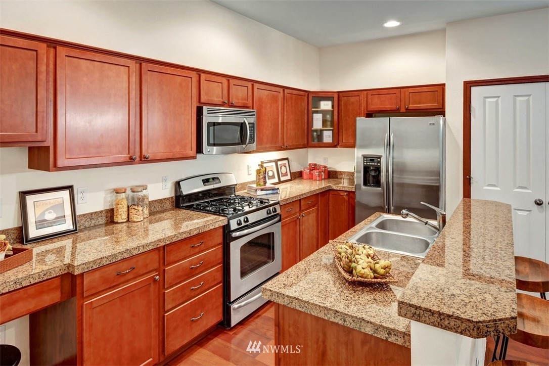 21622 11th Court Southeast Bothell, WA 98021 - Photo 6 of 19 a kitchen with stainless steel appliances granite countertop a sink stove and refrigerator