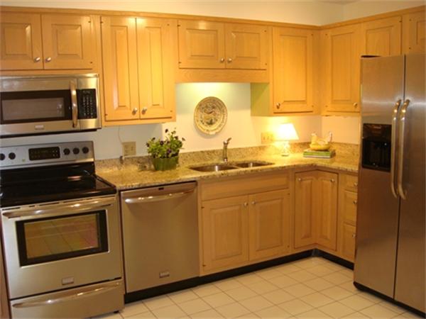 63 Garden Road, Unit G4 Wellesley, MA 02481 - Photo 5 of 8 a kitchen with stainless steel appliances granite countertop a stove a sink and a microwave