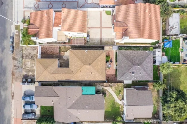 an aerial view of a house with a yard