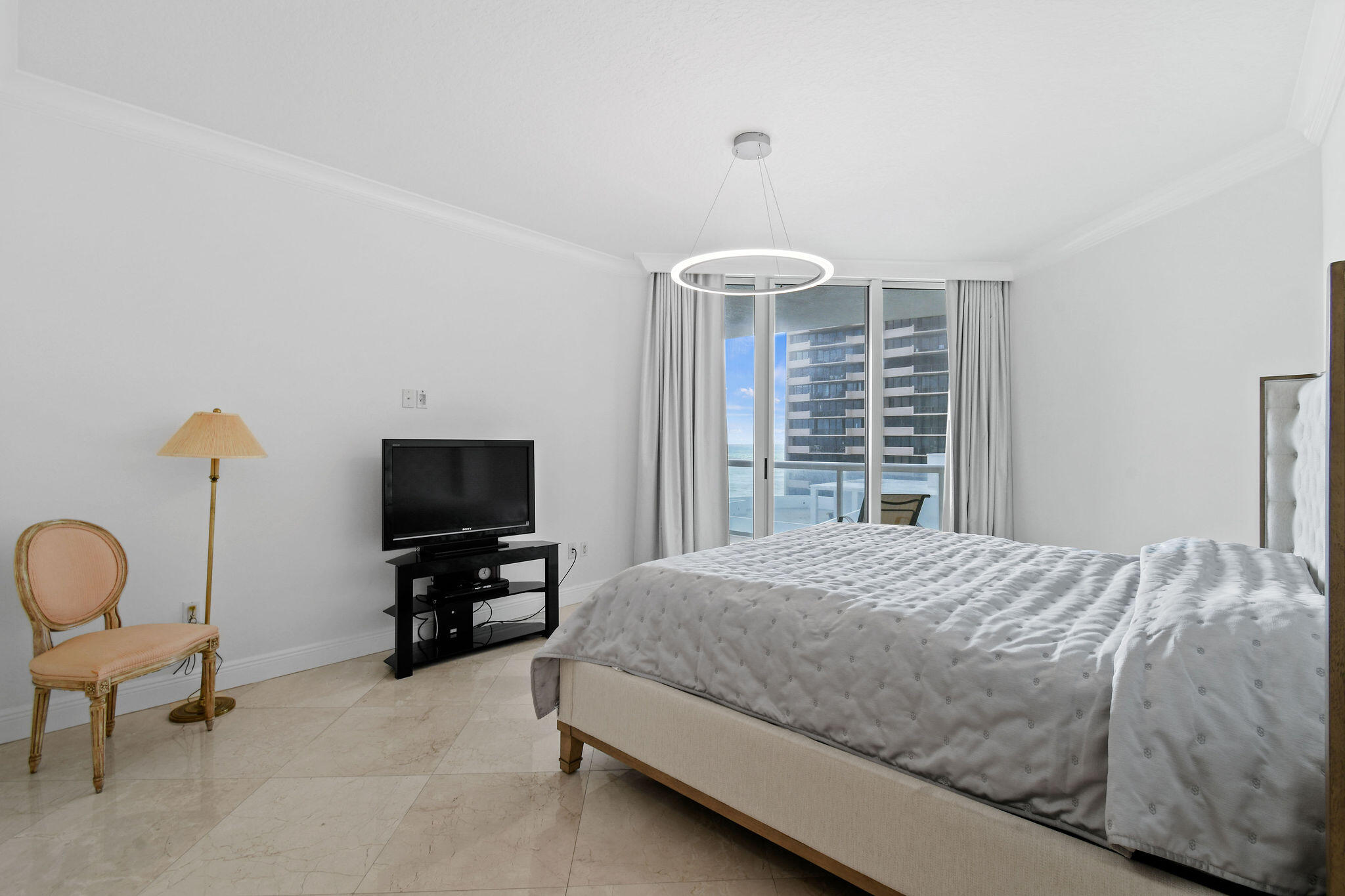 4600 North Ocean Drive, Unit 902 Singer Island, FL 33404 - Photo 32 of 79 a bedroom with a bed and a television