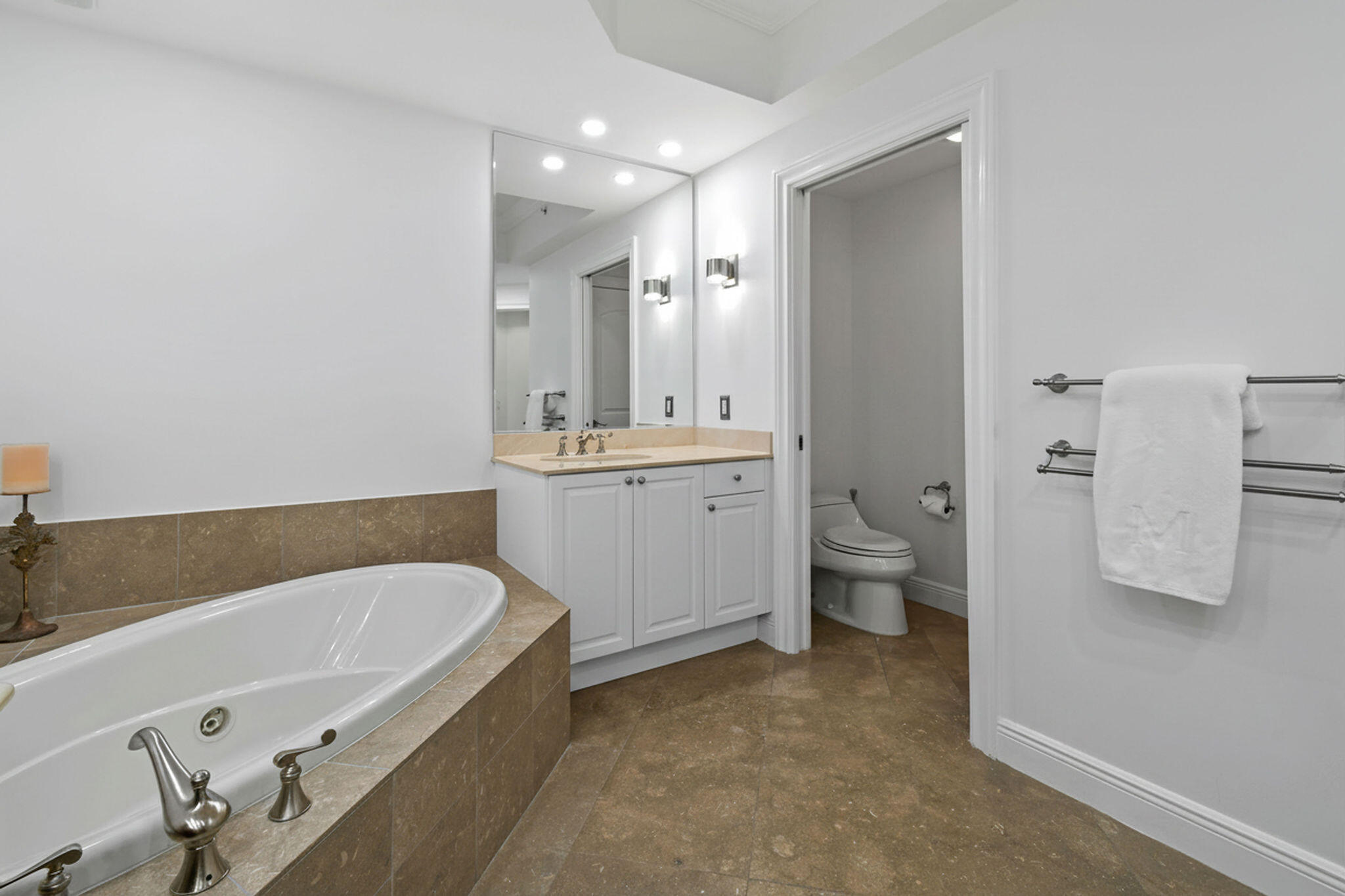 4600 North Ocean Drive, Unit 902 Singer Island, FL 33404 - Photo 41 of 79 a bathroom with a tub sink toilet and mirror