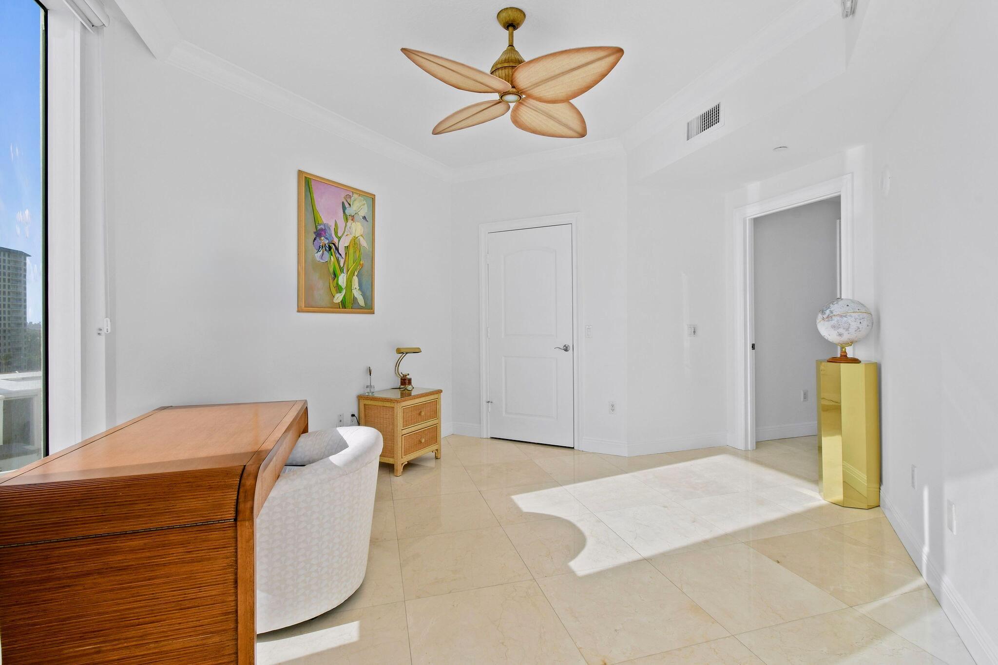 4600 North Ocean Drive, Unit 902 Singer Island, FL 33404 - Photo 42 of 79 a bedroom with a bed and a chandelier