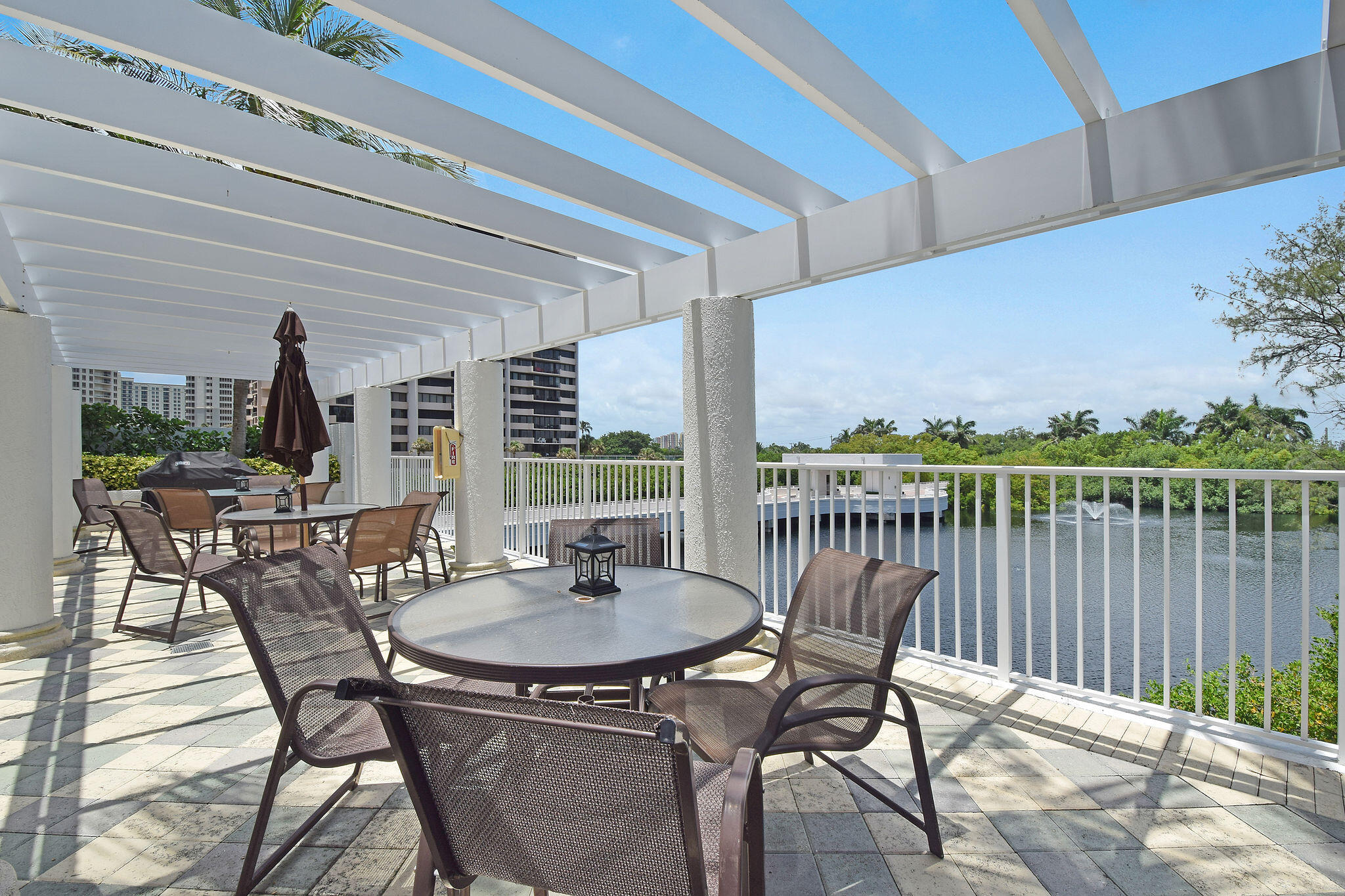 4600 North Ocean Drive, Unit 902 Singer Island, FL 33404 - Photo 58 of 79 a patio with wooden floor and outdoor seating