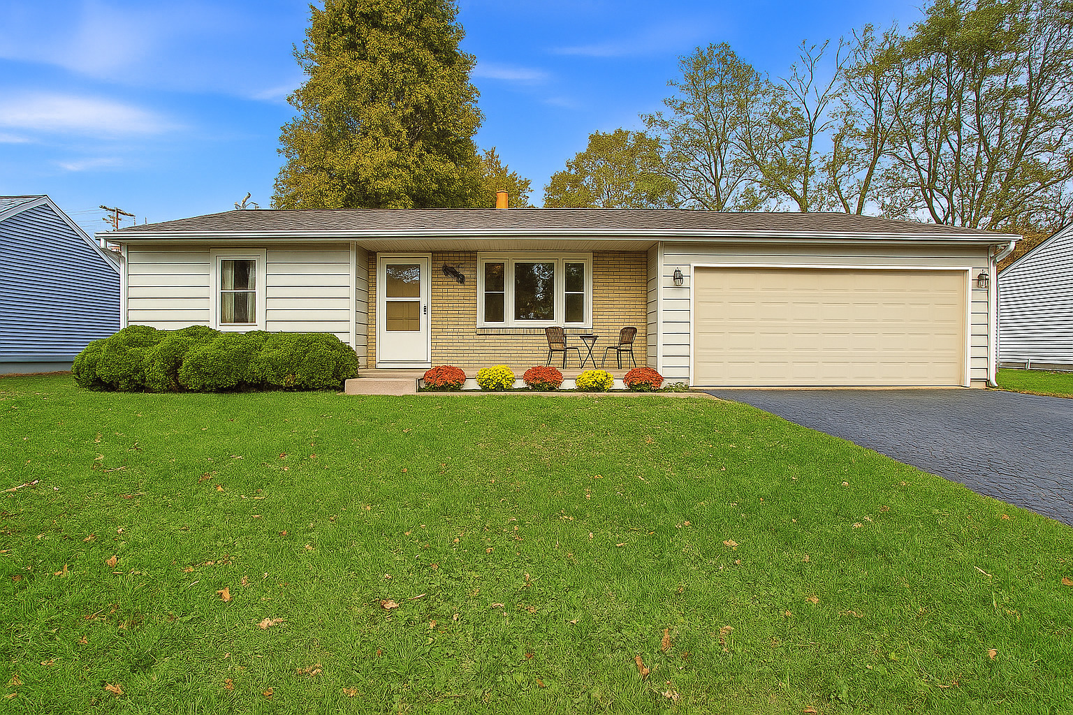 a front view of a house with a garden and yard