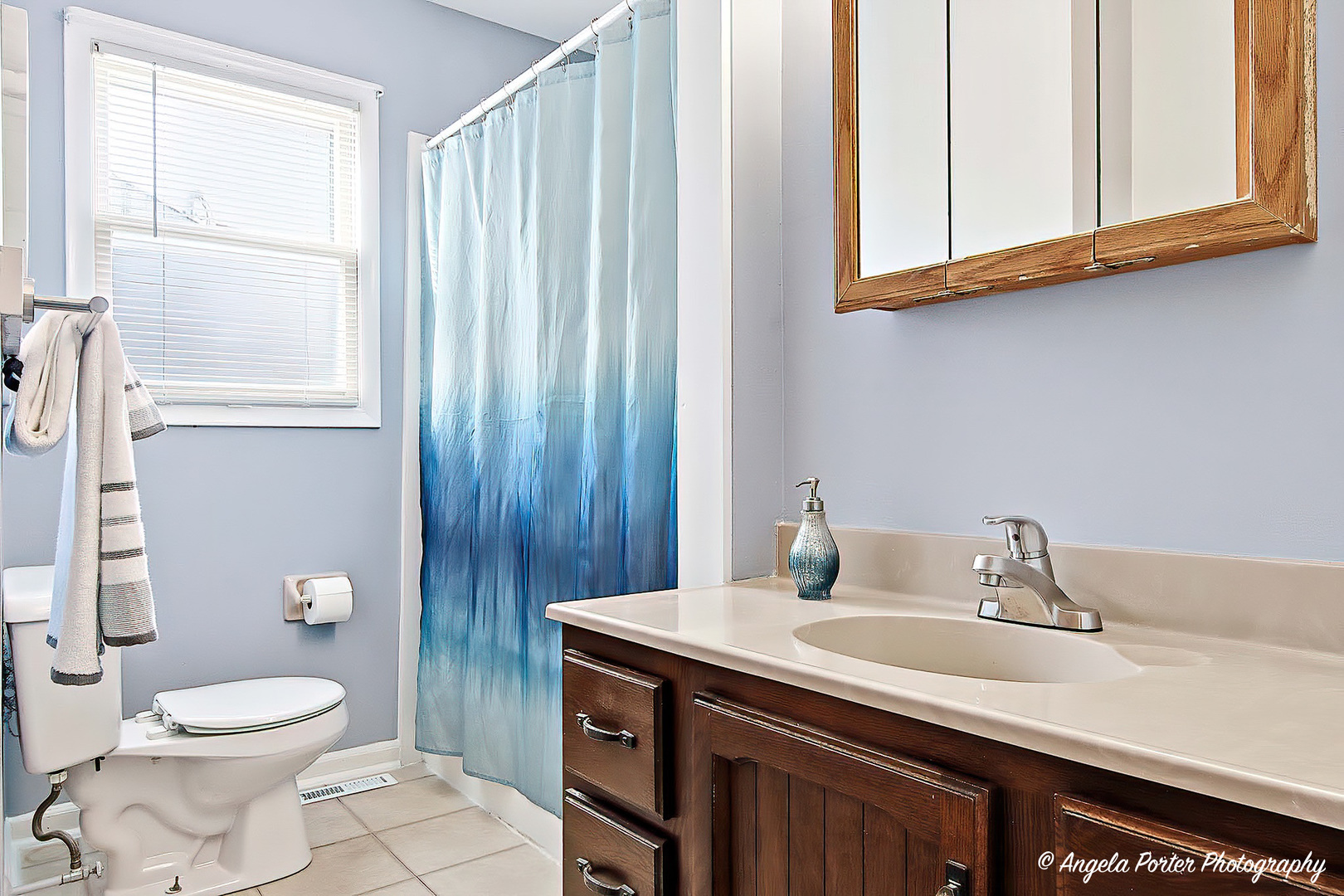 3216 Biscayne Road McHenry, IL 60050 - Photo 12 of 18 a bathroom with a toilet a sink and a window
