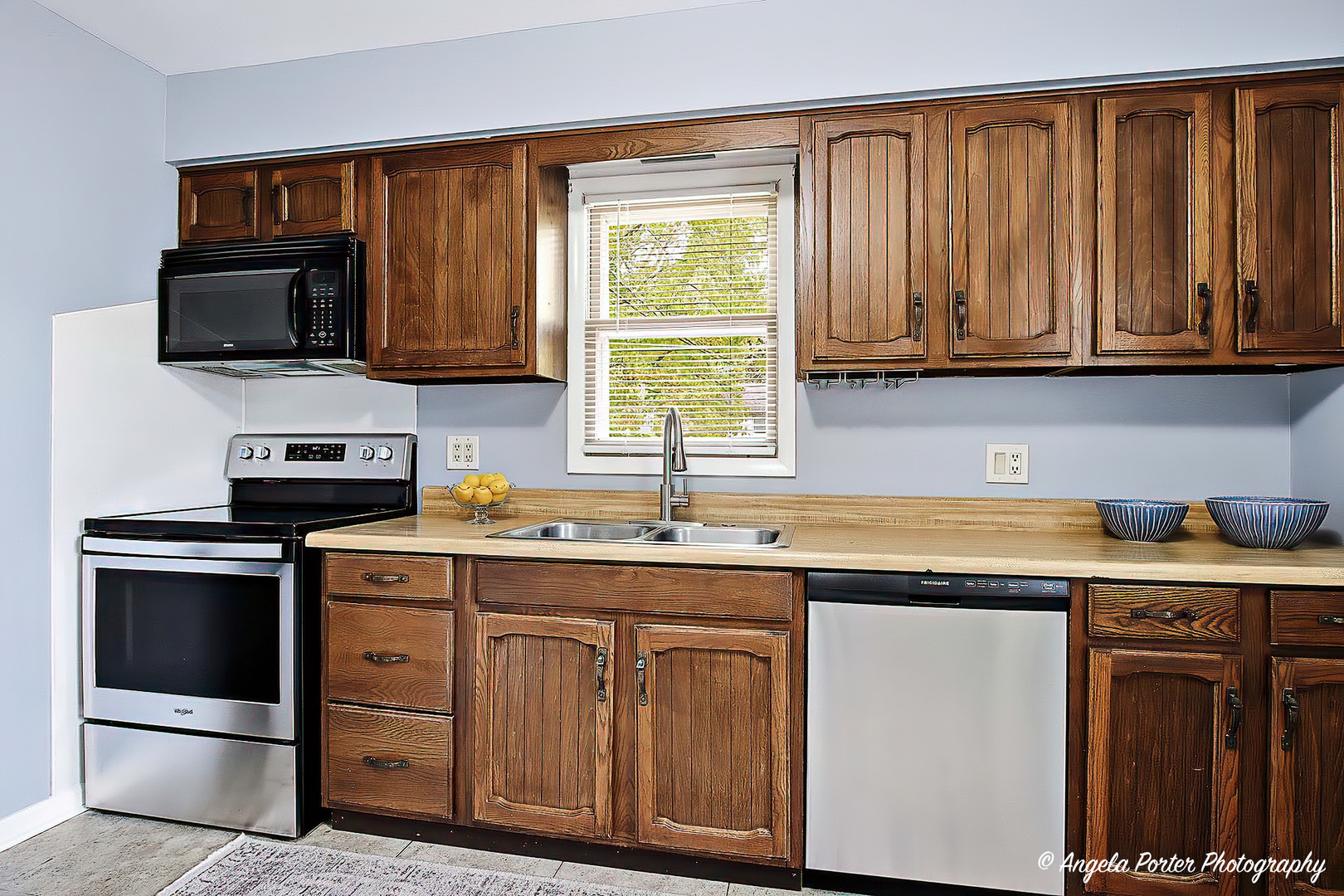 3216 Biscayne Road McHenry, IL 60050 - Photo 3 of 18 a kitchen with stainless steel appliances granite countertop a stove a sink and a microwave