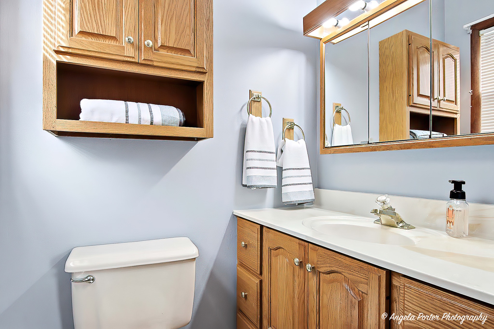3216 Biscayne Road McHenry, IL 60050 - Photo 8 of 18 a bathroom with a sink a toilet and a mirror