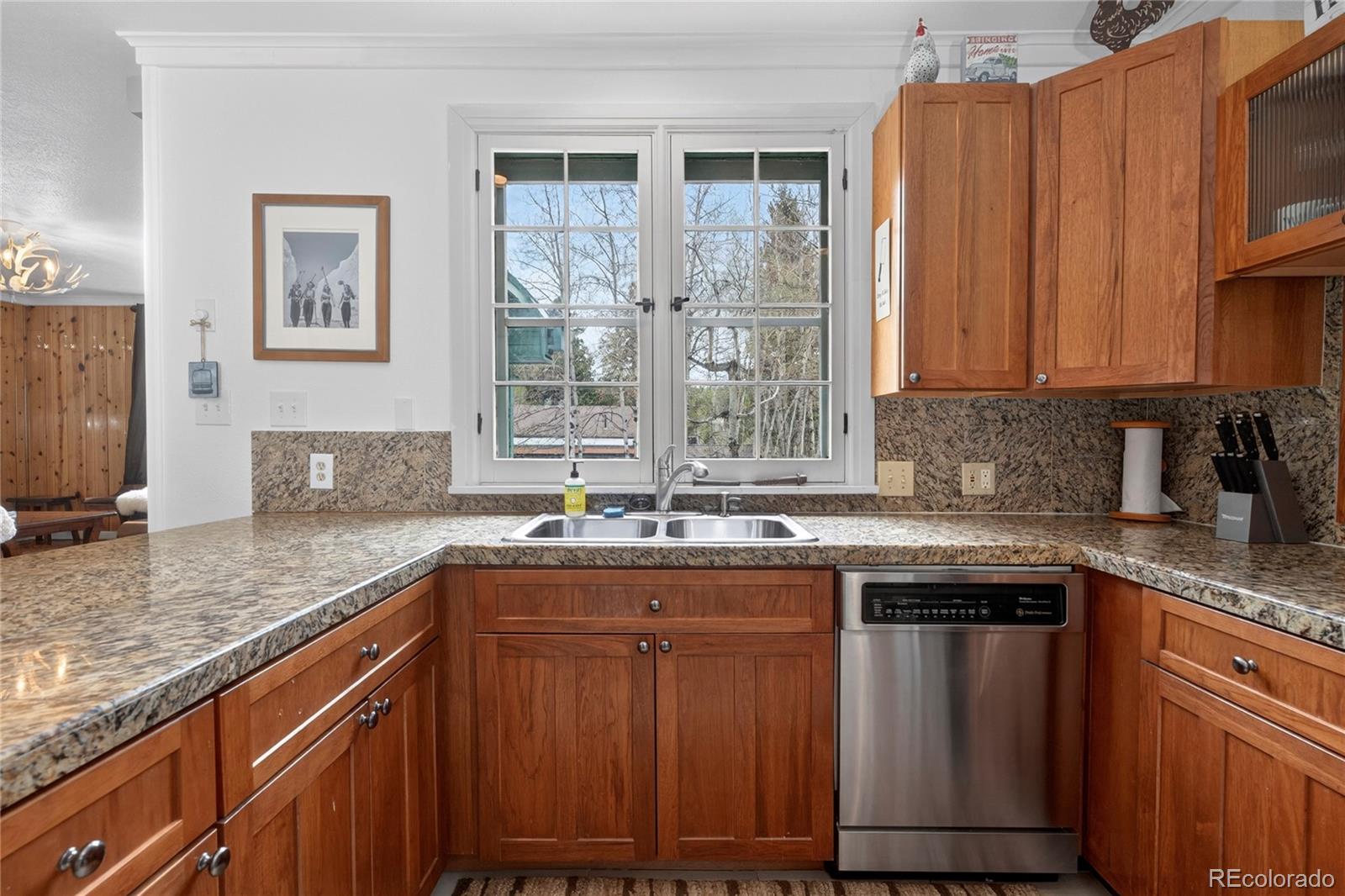 327 Vasquez Road, Unit E1 Winter Park, CO 80482 - Photo 32 of 43 a kitchen with stainless steel appliances granite countertop a sink stove and cabinets