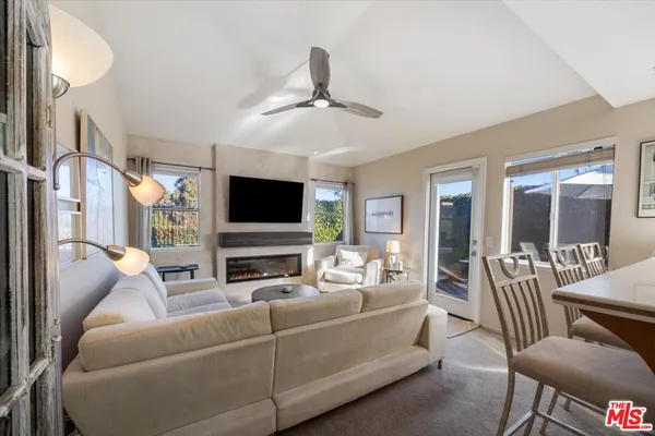 a spacious bedroom with a bed and a flat screen tv