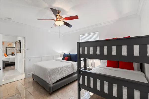 a bedroom with a bed window and mirror