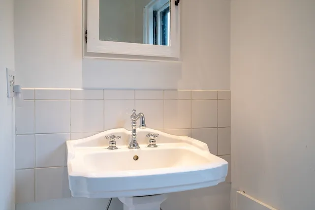 a bathroom with a sink and a window