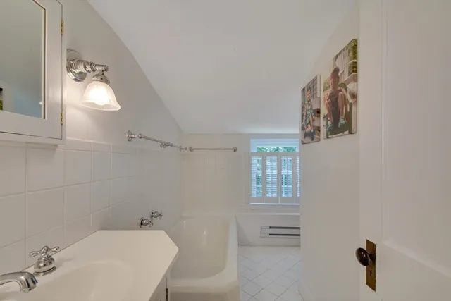 a bathroom with a bathtub and a sink