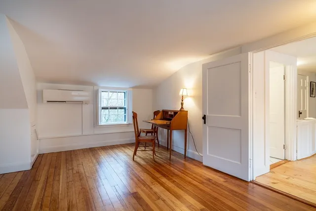 a work room with furniture and wooden floor