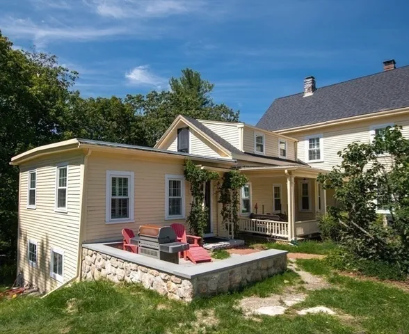 a front view of house with yard outdoor seating and green space