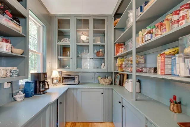 a kitchen with stainless steel appliances cabinets and a table