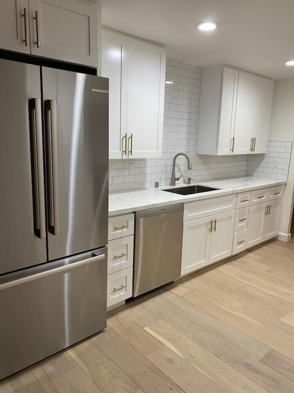 555 Laurel Avenue, Unit 610 San Mateo, CA 94401 - Photo 7 of 14 a kitchen with stainless steel appliances granite countertop a refrigerator a sink and white cabinets