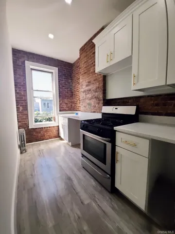 a kitchen with granite countertop wooden cabinets and white appliances