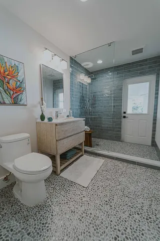 a bathroom with a sink toilet and shower