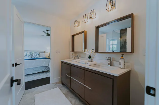 a bathroom with a double vanity sink and a mirror