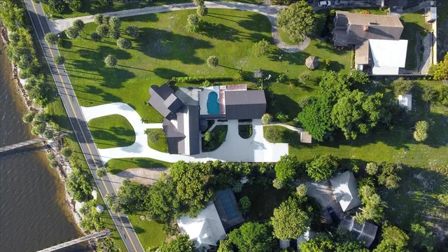 an aerial view of residential house with outdoor space and swimming pool