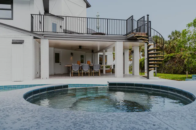 a view of a house with swimming pool and porch