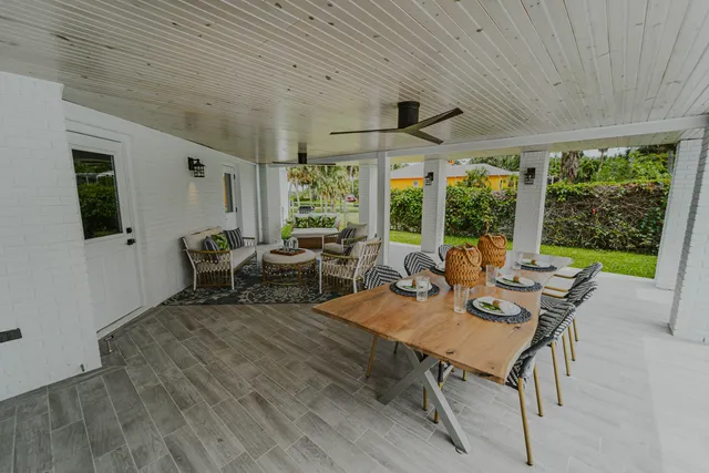 a view of a patio with table and chairs