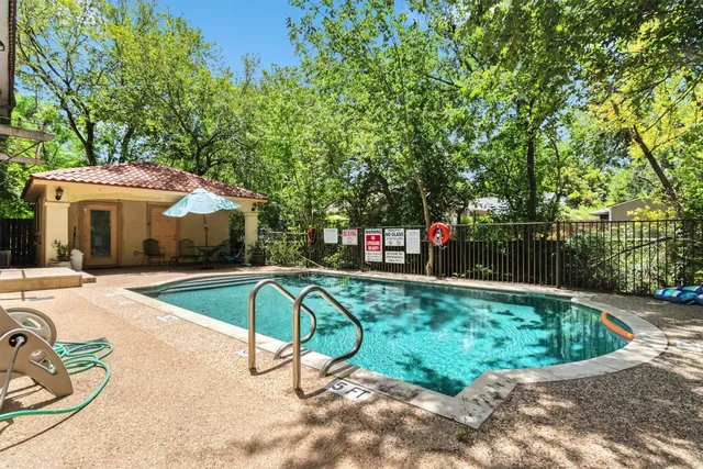 a view of a swimming pool with a patio