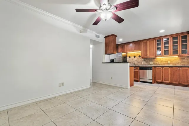 a kitchen with stainless steel appliances granite countertop a stove sink and cabinets
