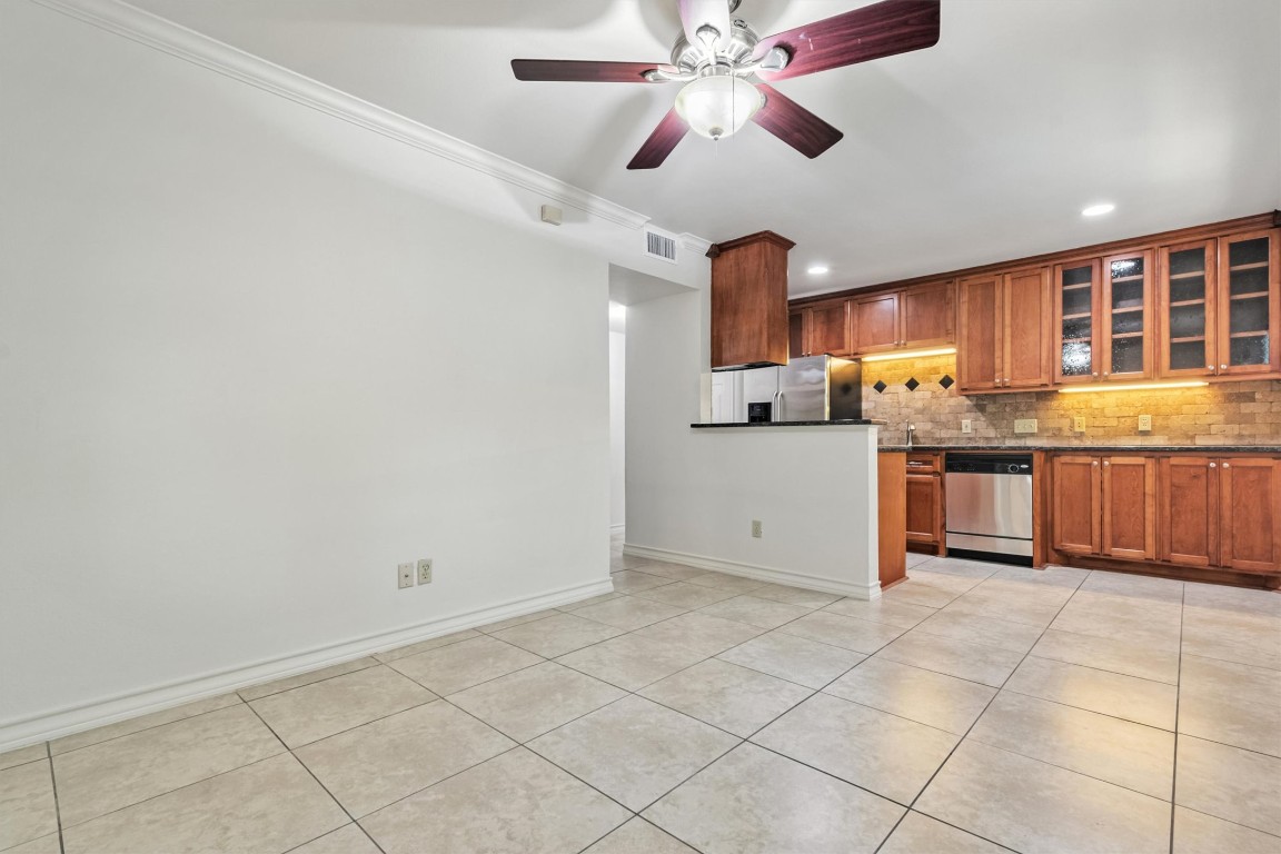 407 East 45th Street, Unit 111 Austin, TX 78751 - Photo 4 of 15 a kitchen with stainless steel appliances granite countertop a stove sink and cabinets