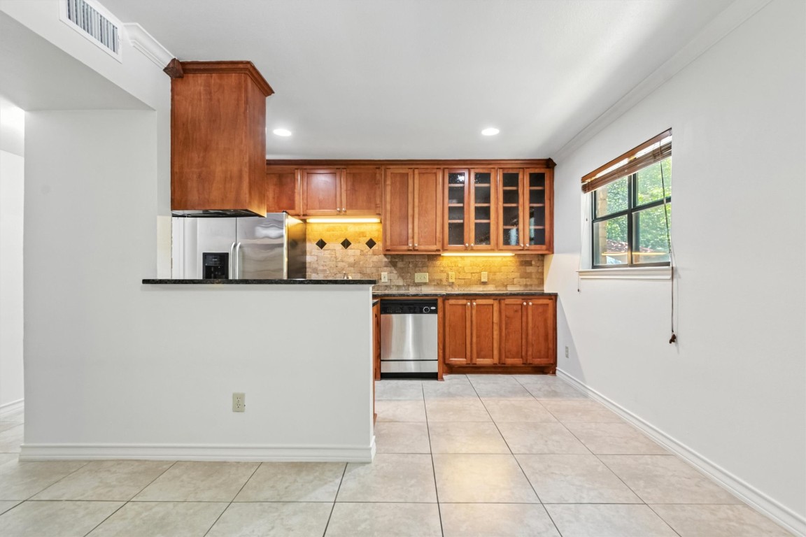 407 East 45th Street, Unit 111 Austin, TX 78751 - Photo 7 of 15 a kitchen with a sink and a refrigerator