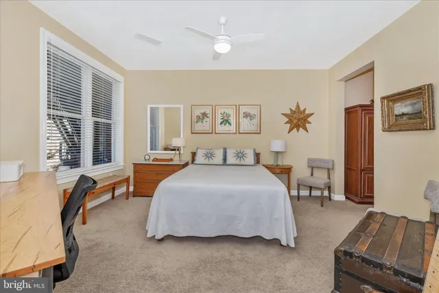 a bedroom with a bed and a desk