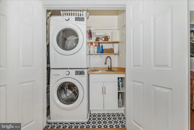 a kitchen with stainless steel appliances a dining table chairs and a refrigerator