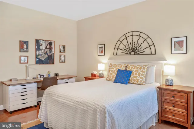 a bed room with a bed a mirror and dresser