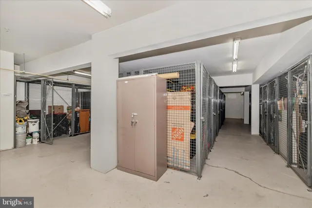 a view of swimming pool with outdoor seating and trees in the background