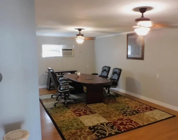 a view of a dining room with a table and chairs
