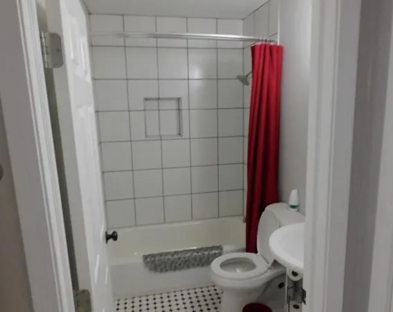 a bathroom with a toilet and a shower
