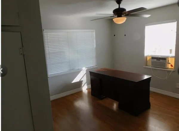 a room with wooden floor and a window