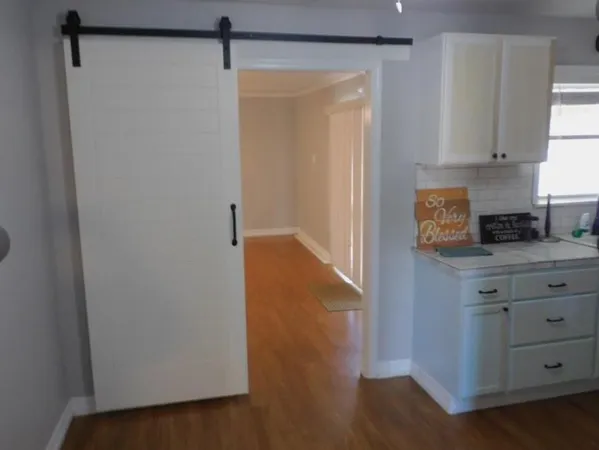 a view of a kitchen with electric appliances