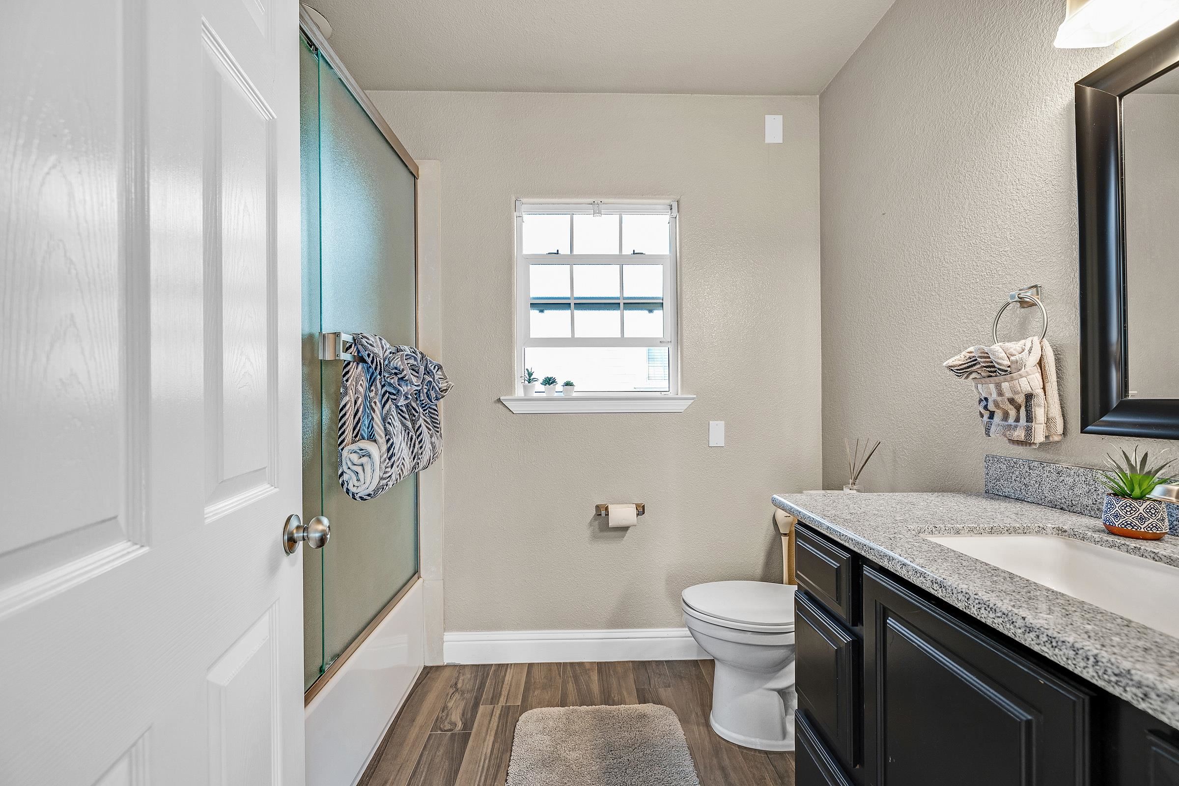 339 I Street Fremont, CA 94536 - Photo 15 of 60 a bathroom with a granite countertop sink toilet and shower