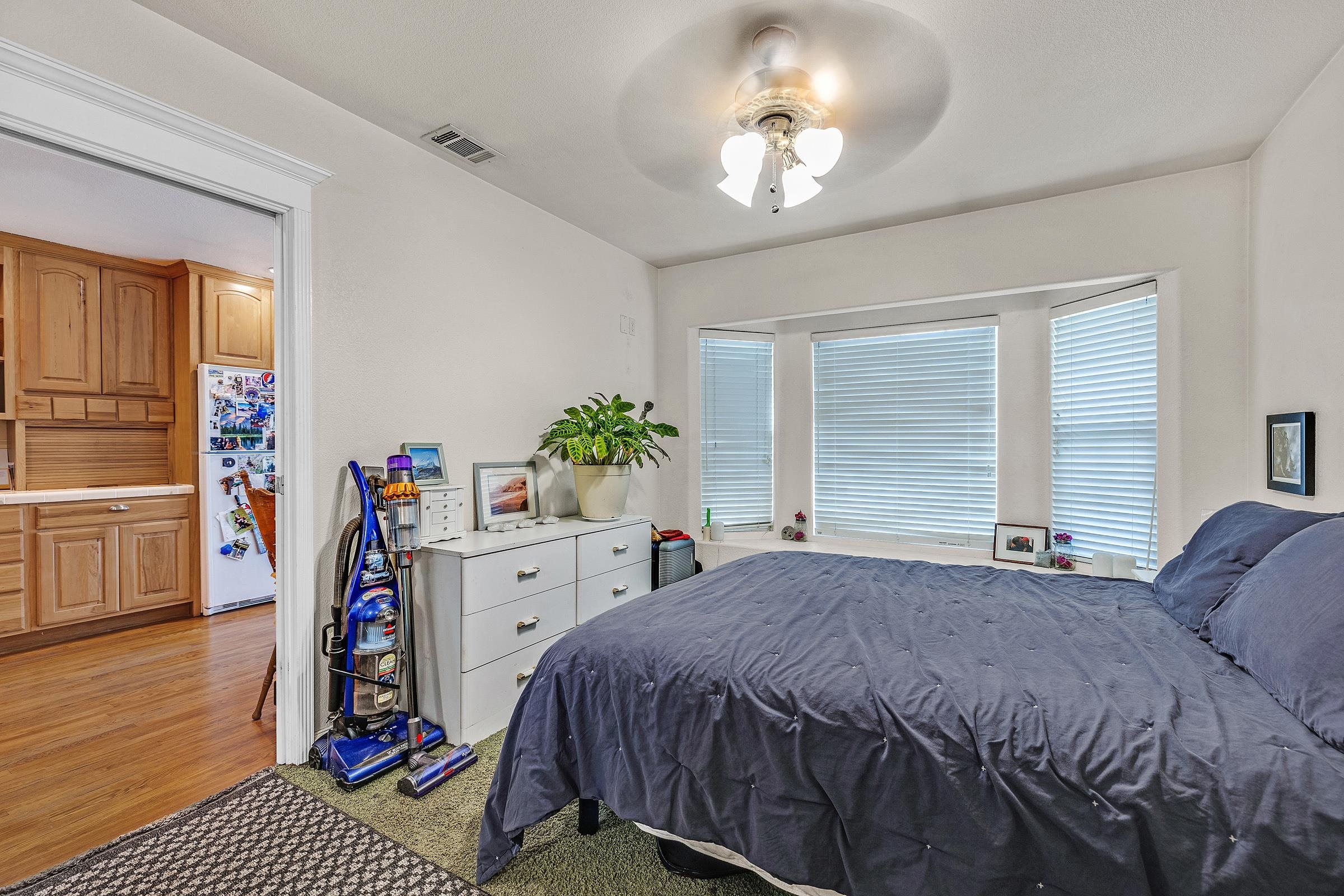 339 I Street Fremont, CA 94536 - Photo 26 of 60 a bed room with a bed and a chandelier