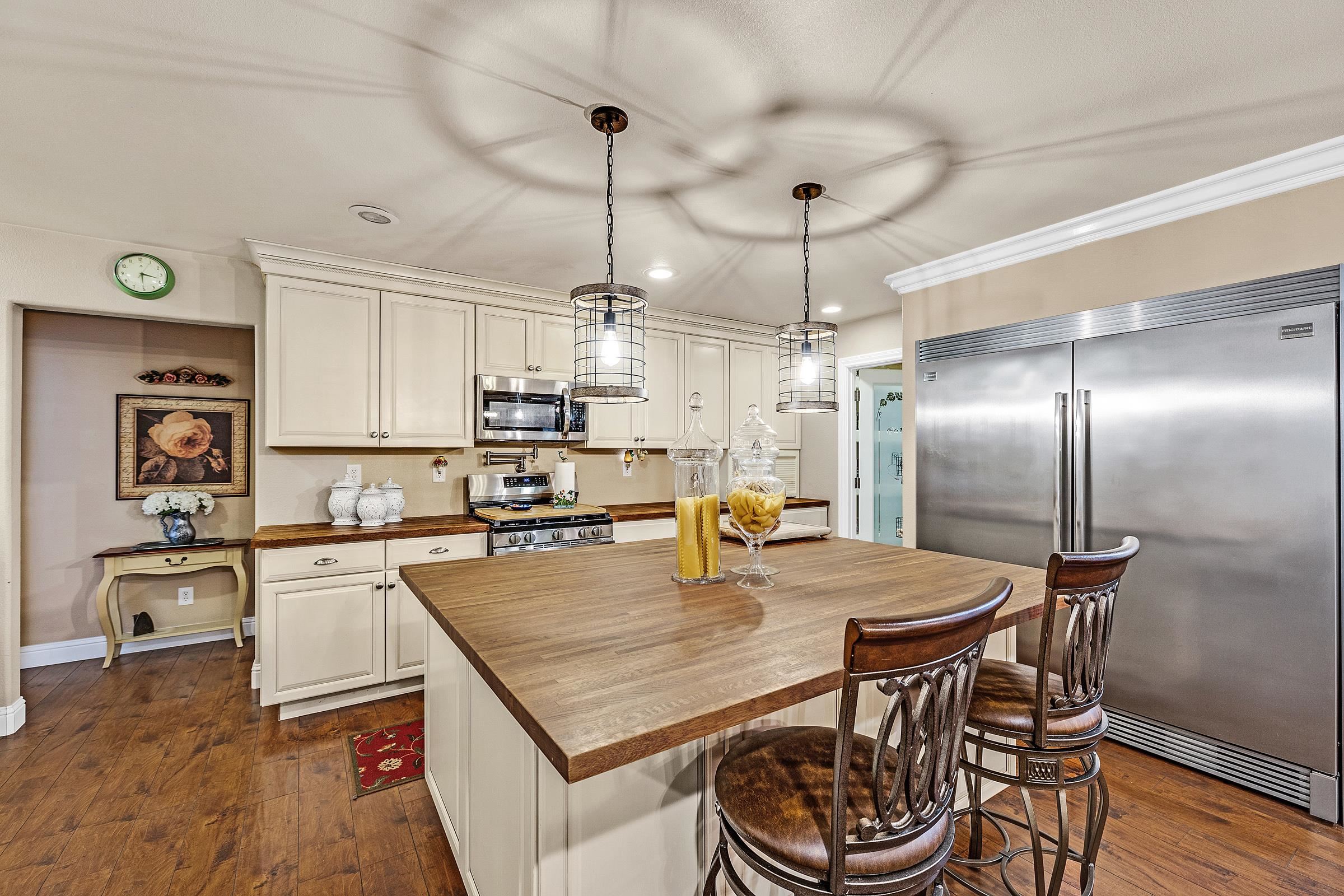 339 I Street Fremont, CA 94536 - Photo 34 of 60 a kitchen with a table chairs refrigerator and microwave