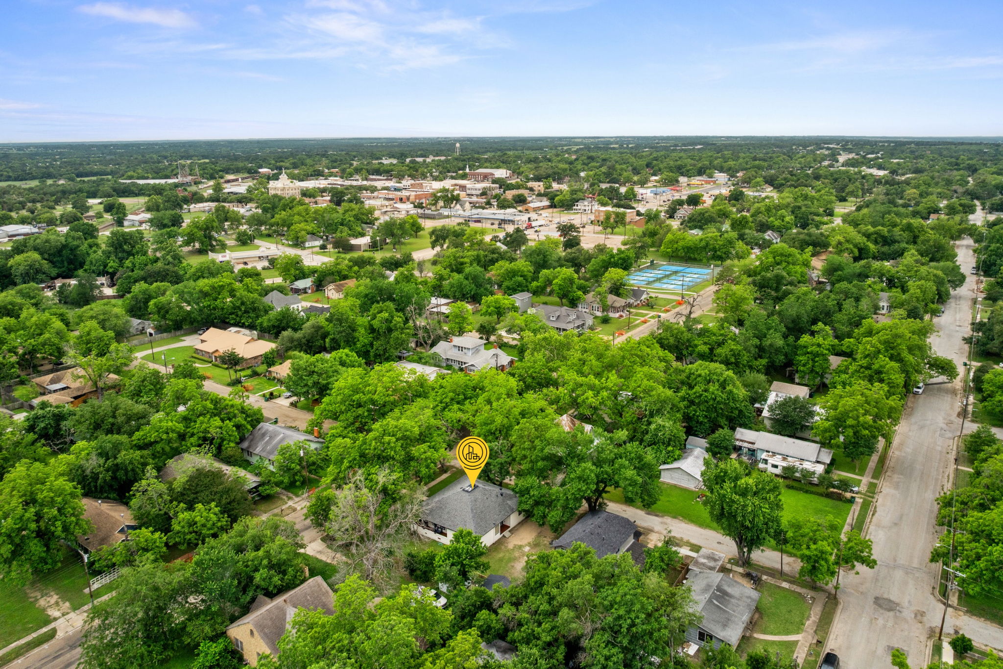 602 East 6th Street Cameron, TX 76520 - Photo 40 of 40 Aerial perspective showcasing the residential streetscape with mature tree canopy