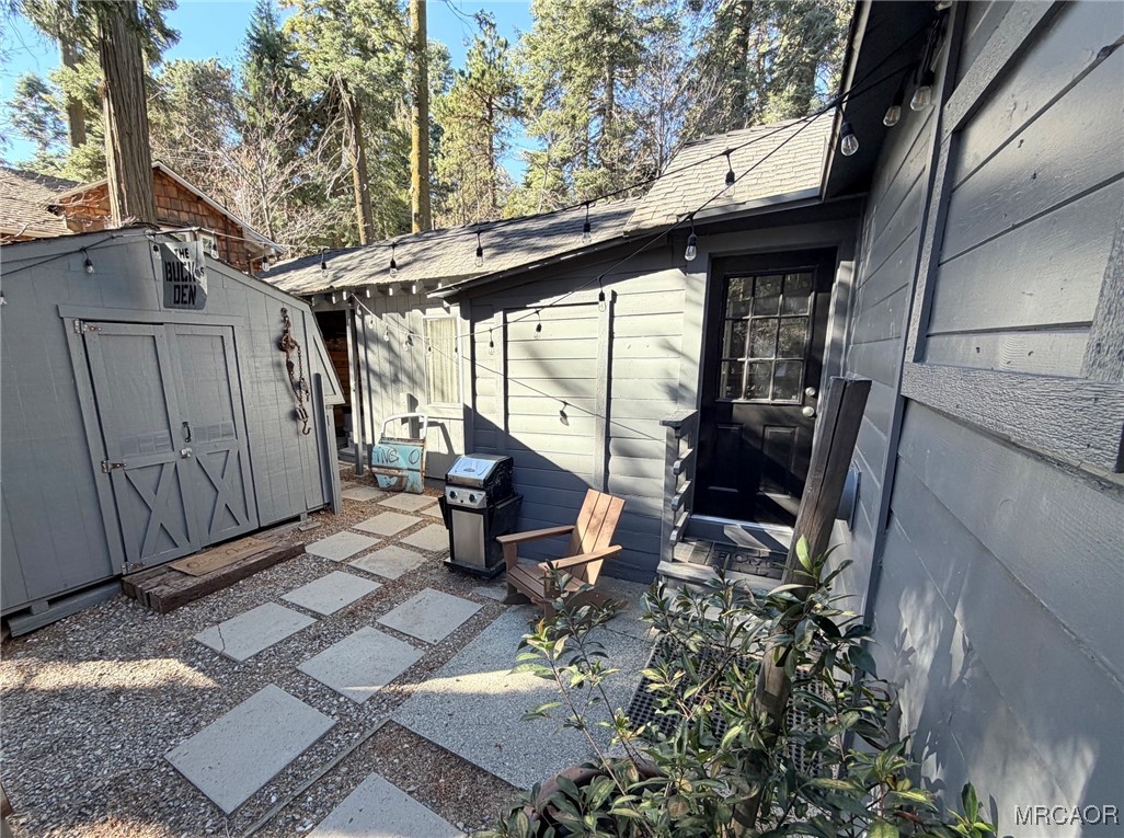 926 Kuffle Canyon Road Skyforest, CA 92385 - Photo 7 of 35 a view of a patio with table and chairs and wooden fence with potted plants